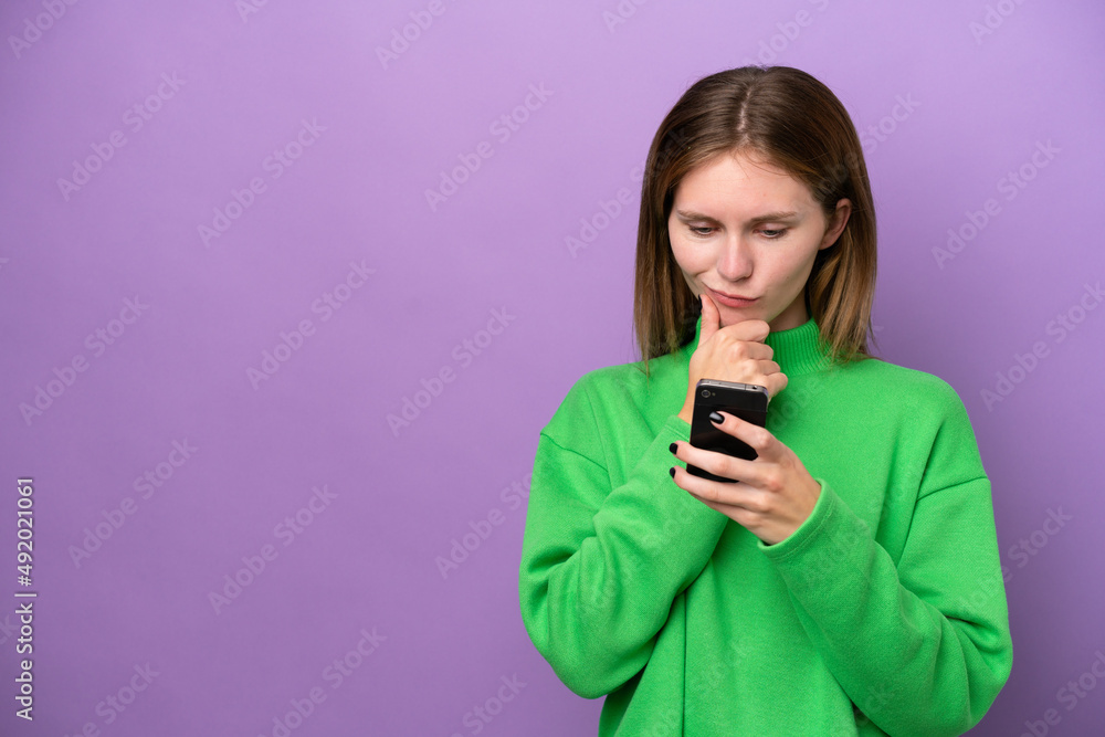 Young English woman isolated on purple background thinking and sending a message Young English woman isolated on purple background thinking and sending a message
