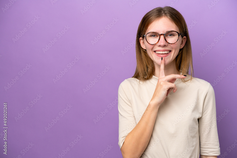 Young English woman isolated on purple background showing a sign of silence gesture putting finger in mouth Young English woman isolated on purple background showing a sign of silence gesture putting finger in mouth