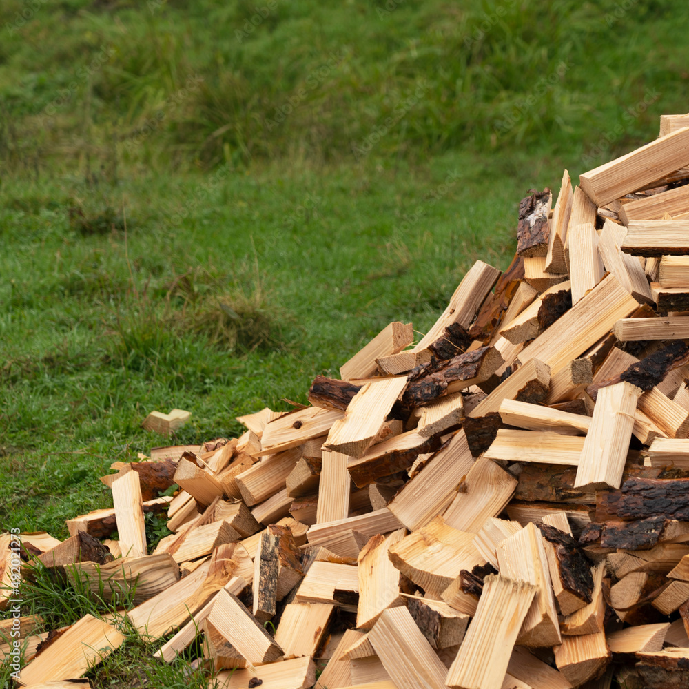 Chopped firewood stacked on a pile. preparation of fuel for heating in winter Chopped firewood stacked on a pile. preparation of fuel for heating in winter