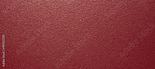 The texture of the red matte plastic.Red matte background.The background is red rough plastic.