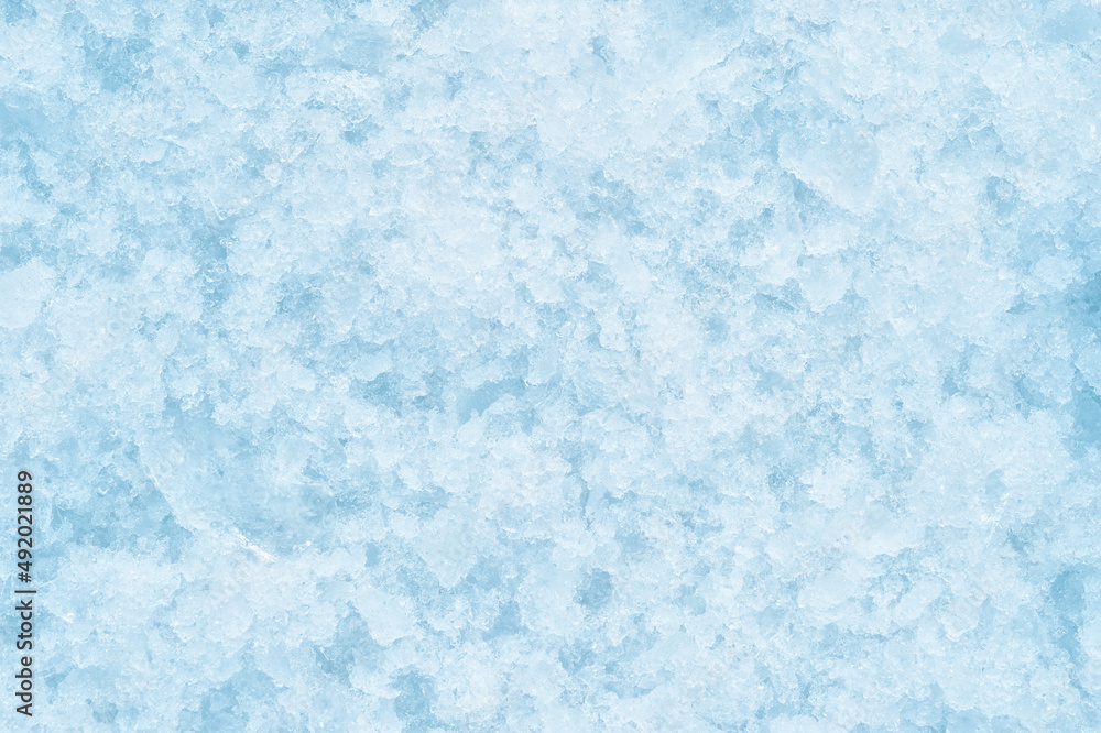 A texture of crumbling ice with soft shadows. The concept of the background of freezing products. Background. Top view. Flat lay A texture of crumbling ice with soft shadows. The concept of the background of freezing products. Background. Top view. Flat lay
