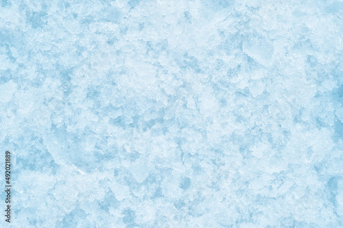 A texture of crumbling ice with soft shadows. The concept of the background of freezing products. Background. Top view. Flat lay