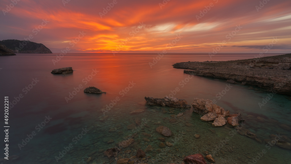 Caló de s'Illa at sunset view with red sky , Ibiza Caló de s'Illa at sunset view with red sky , Ibiza