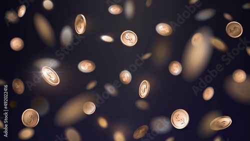 Falling golden coins with blur effect on dark background