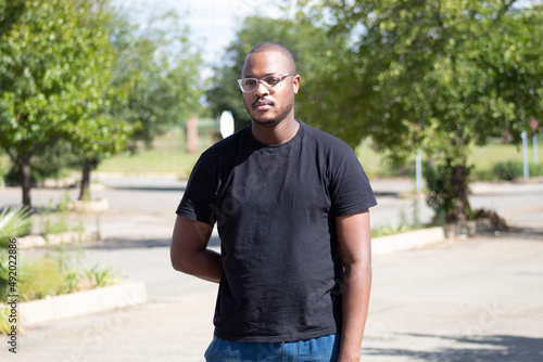 Black African Man looking into the camera with one hand at his back