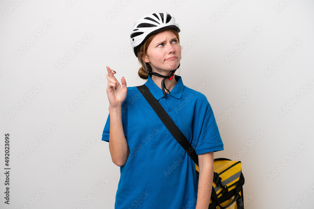 Young English woman with thermal backpack isolated on white background with fingers crossing and wishing the best Young English woman with thermal backpack isolated on white background with fingers crossing and wishing the best