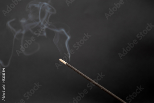 Aromatic smoking stick on a black background