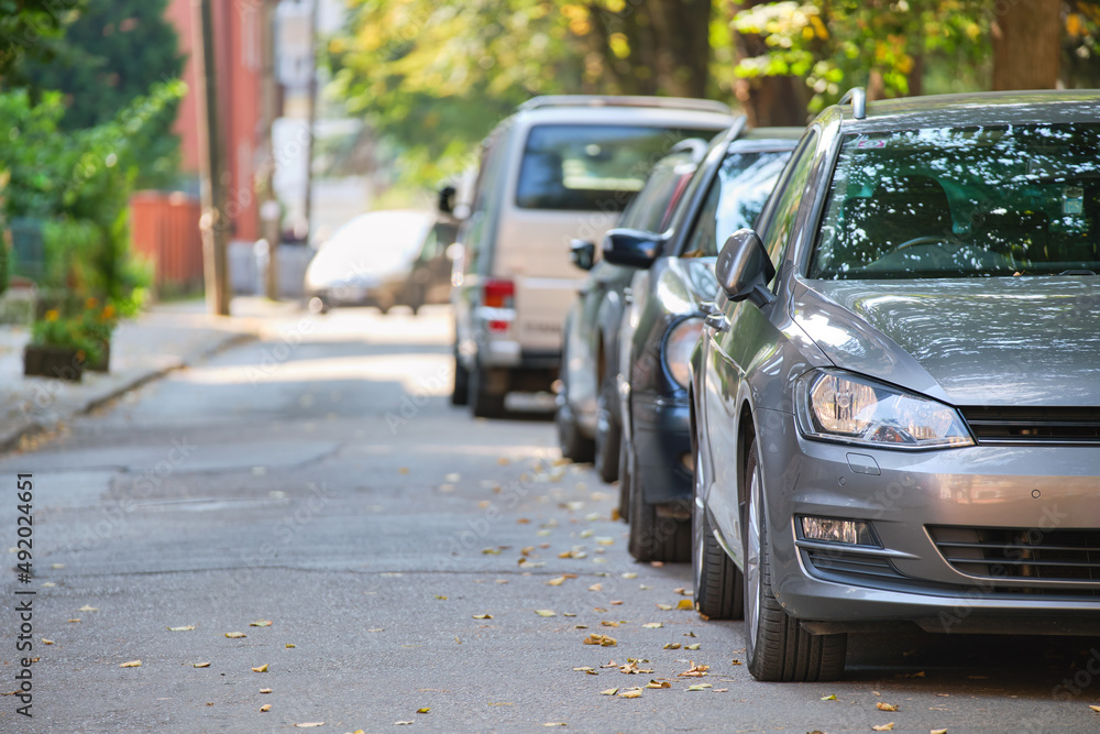 City traffic with cars parked in line on street side