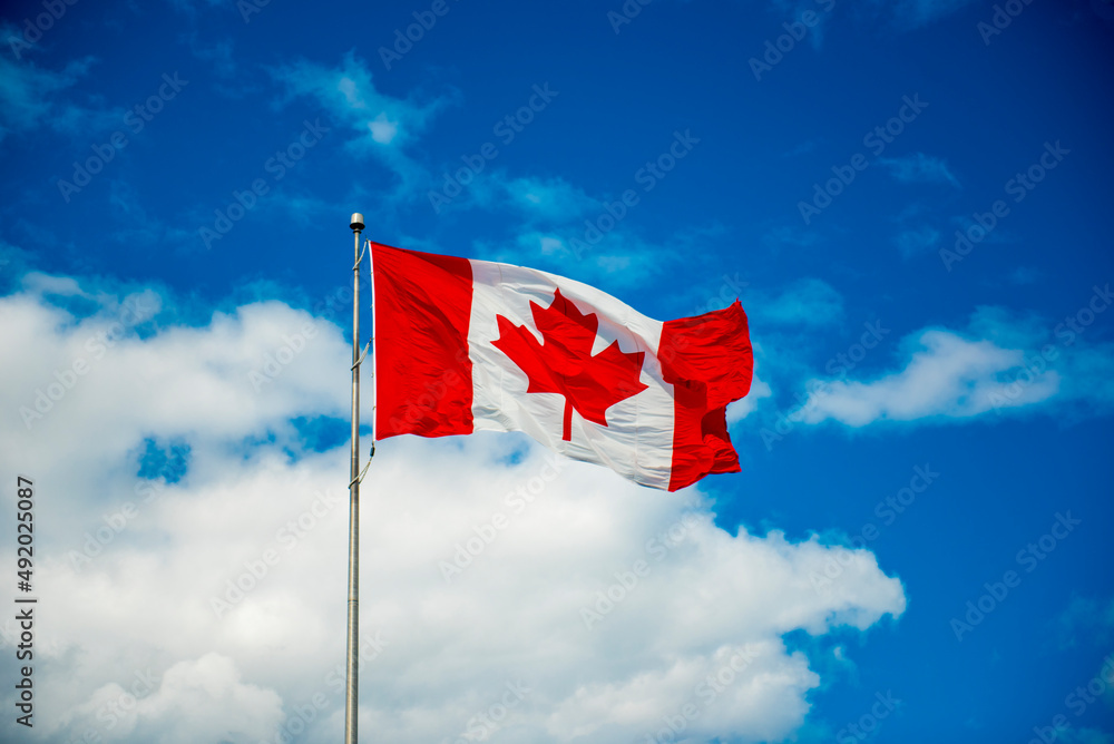 canadian flag against sky canadian flag against sky