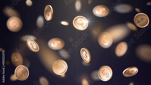 Falling golden coins with blur effect on dark background