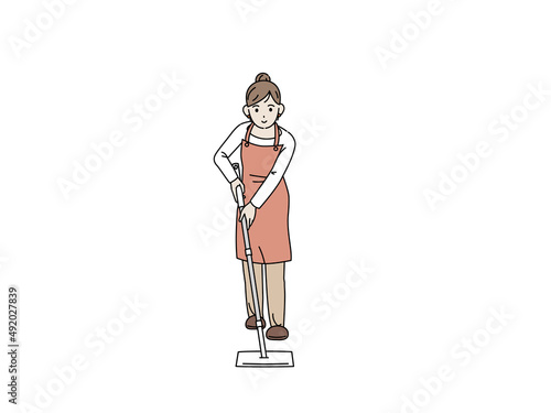 フローリングワイパーで床を掃除する主婦　エプロン姿の女性