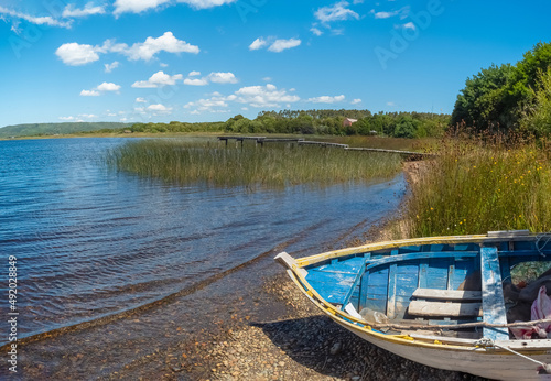 Old fishing boat on a lake in the Chiloé National Park on the western coast of Chiloé Island, Los Lagos Region (region of the lakes), Chile photo