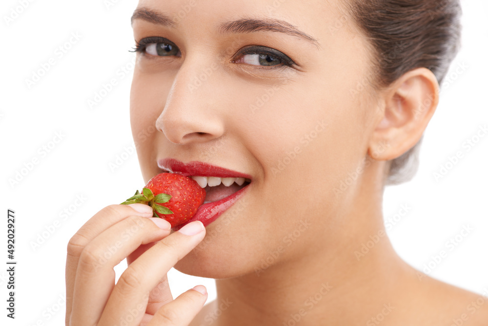 Luscious red lips. Cropped portrait of a beautiful young woman biting into a strawberry. Luscious red lips. Cropped portrait of a beautiful young woman biting into a strawberry.