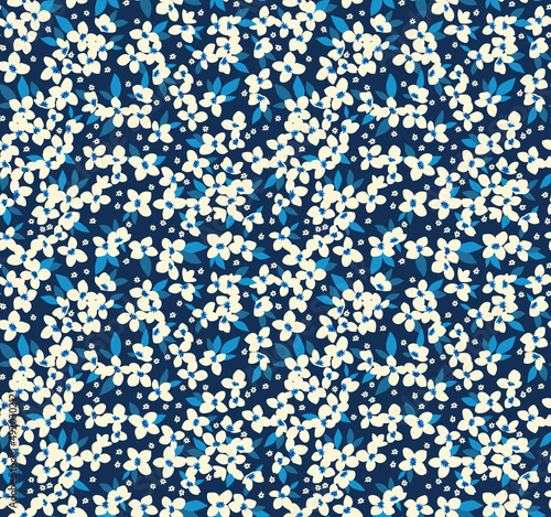 Vector seamless pattern. Pretty pattern in small flowers. Small white pastel flowers. Dark blue background. Ditsy floral background. The elegant the template for fashion prints. Stock vector.