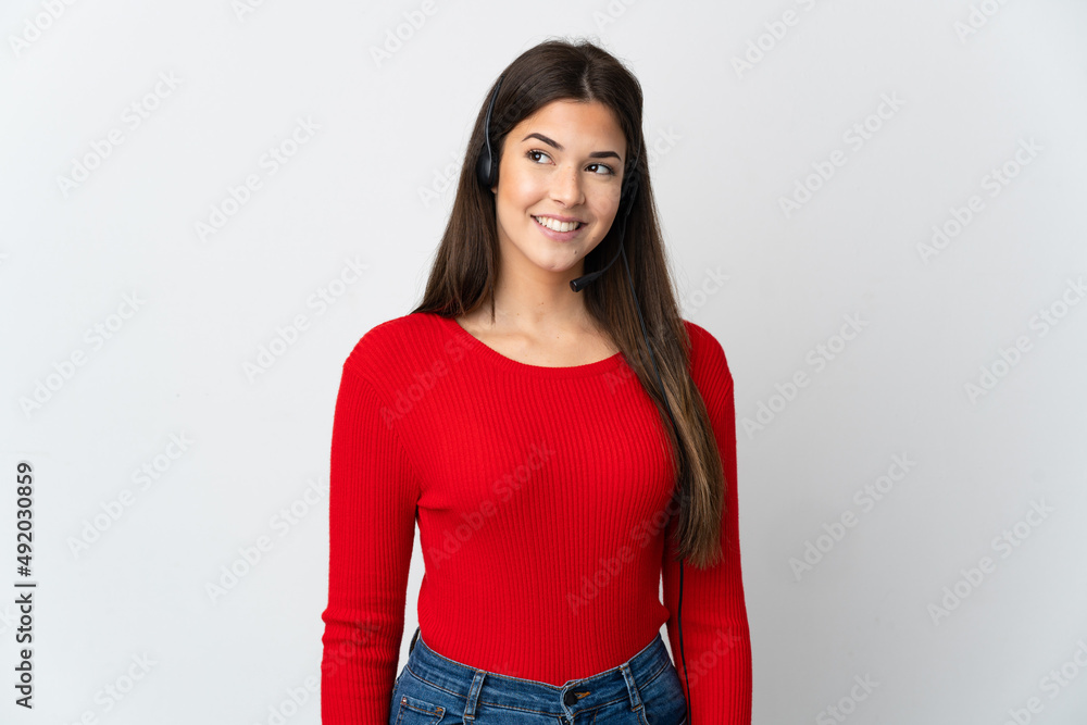 Young Brazilian telemarketer girl over isolated background looking to the side and smiling Young Brazilian telemarketer girl over isolated background looking to the side and smiling