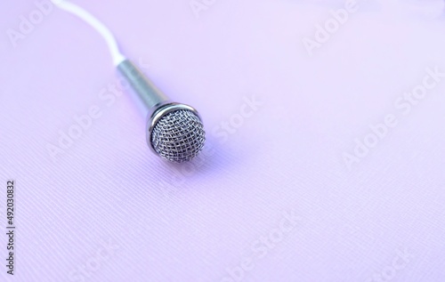 microphone on pastel violet background