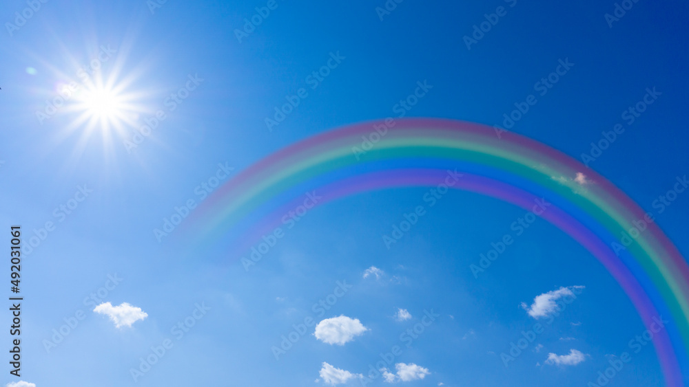 Bright blue sky with rainbow and sunshine_wide_10 Bright blue sky with rainbow and sunshine_wide_10