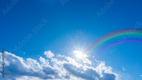 Bright blue sky with rainbow and sunshine_wide_06