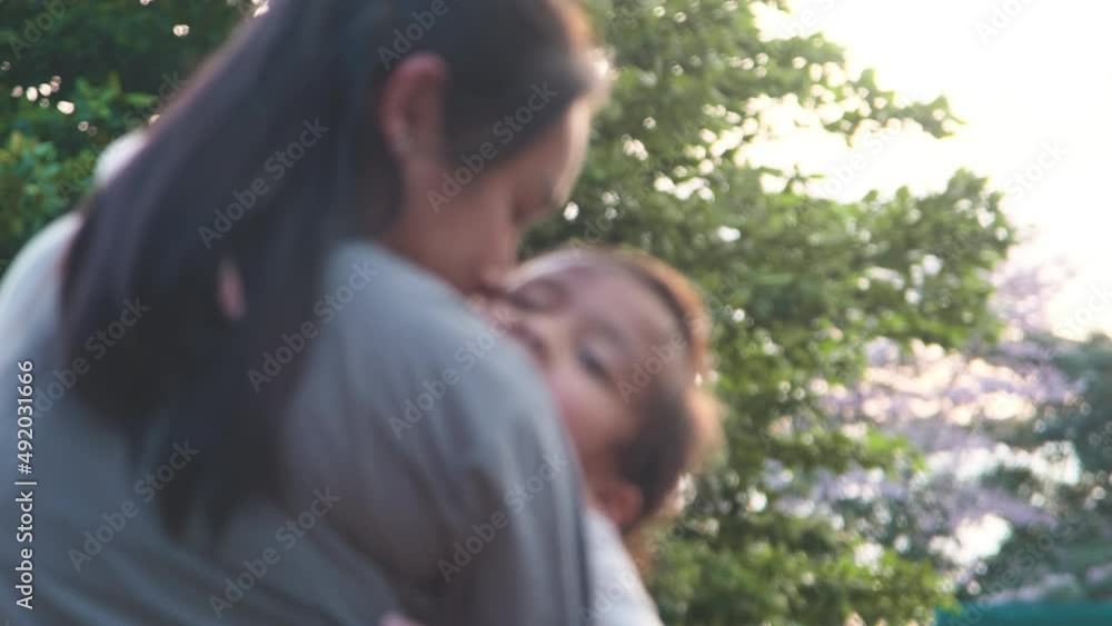 Little daughter ran to her mother and hugged her in the park in autumn. Cute kid is having fun with mommy in playground Little daughter ran to her mother and hugged her in the park in autumn. Cute kid is having fun with mommy in playground