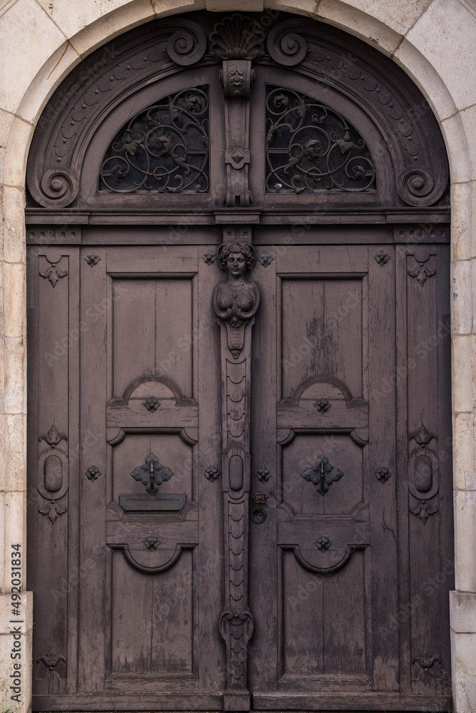 Munich, Germany - December 20,2021: Old Decorative Main Entrance Wooden Door.