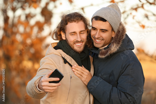 Happy gay couple taking sel...