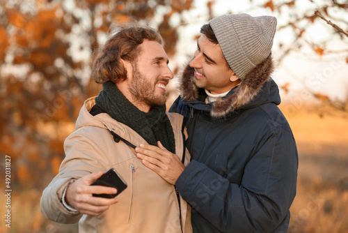 Happy gay couple taking sel...