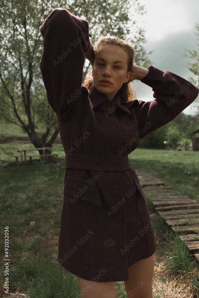 Fashion portrait of a beautiful and cute girl in nature in stylish clothes Fashion portrait of a beautiful and cute girl in nature in stylish clothes