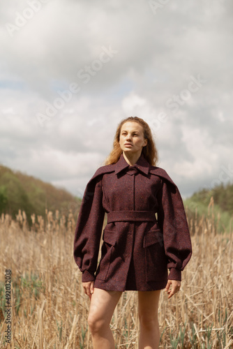 Fashion portrait of a beautiful and cute girl in nature in stylish clothes © alexbutko_com