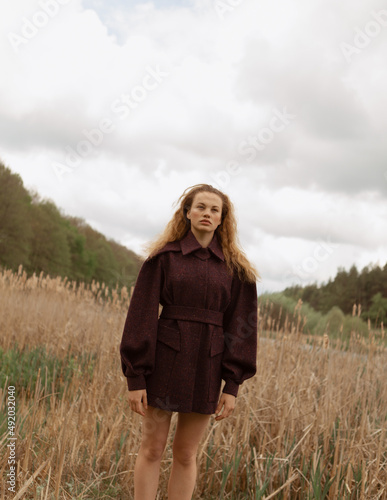 Fashion portrait of a beautiful and cute girl in nature in stylish clothes © alexbutko_com