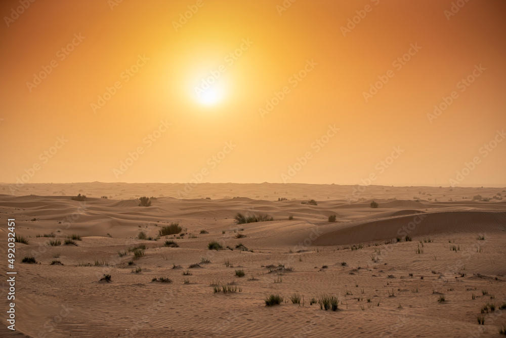 Sunset at the Edge of the Rolling Sand Dunes in the Empty Quarter (Arabian Desert) outside Abu Dhabi, United Arab Emirates Sunset at the Edge of the Rolling Sand Dunes in the Empty Quarter (Arabian Desert) outside Abu Dhabi, United Arab Emirates