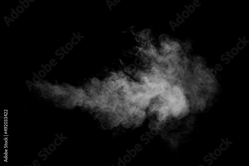 A swirling vertical vapor isolated on a black background for overlaying on your photos. Fragment of horizontal steam. Abstract smoky background, design element