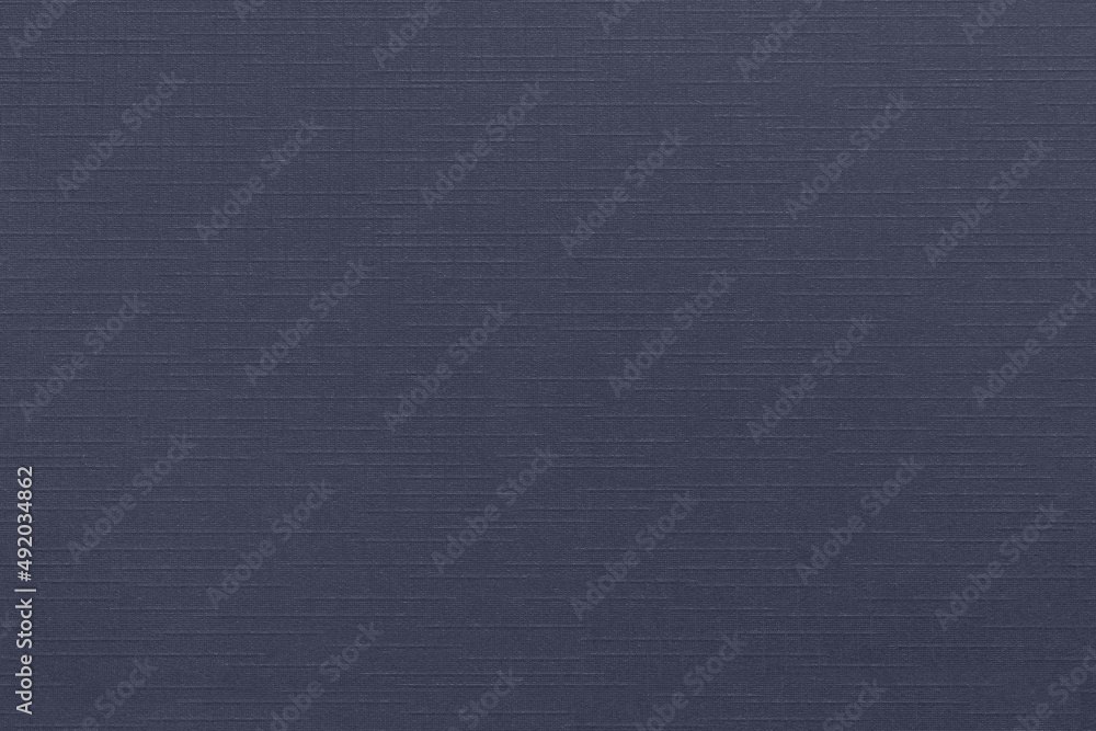 Dark blue design paper background with linen texture. Blank sheet of decorative cardboard with copy space