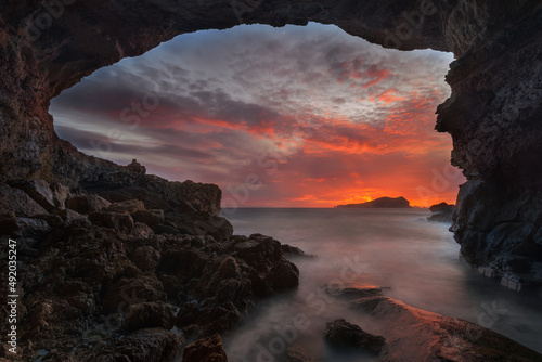 Sa Figuera Borda Cave at sunset with red sky , Ibiza  photo