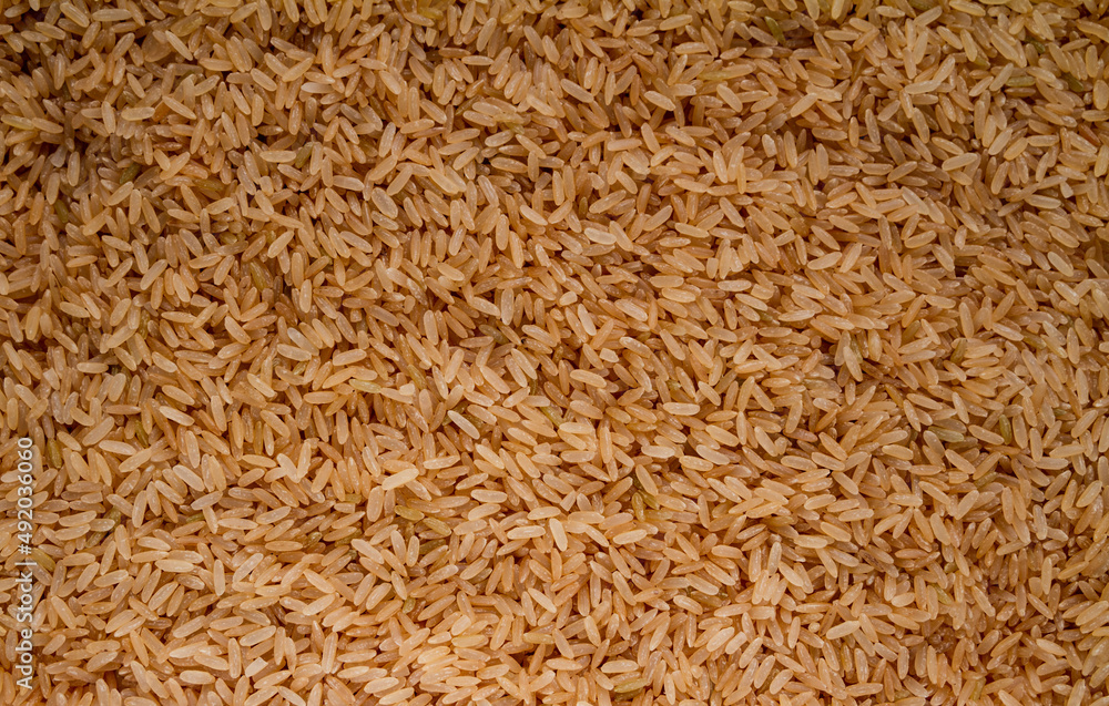 Brown whole grain rice background texture.