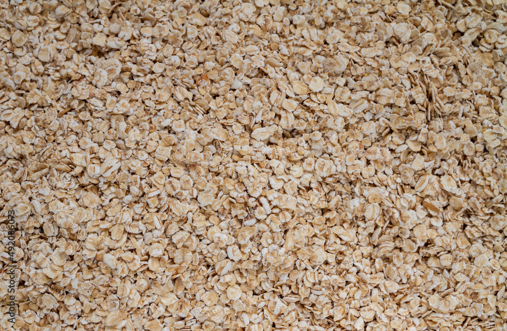 Rolled oats or oat flakes, whole-grain cereal background texture. Rolled oats or oat flakes, whole-grain cereal background texture.