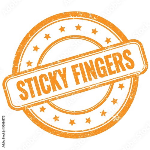 STICKY FINGERS text on orange grungy round rubber stamp.