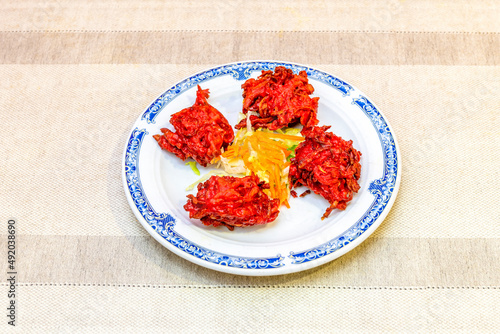 Bhaji is a word extended in the West to designate what in India is better known as pakora, a set of appetizers consisting of all kinds of vegetables battered with fried chickpea flour. photo