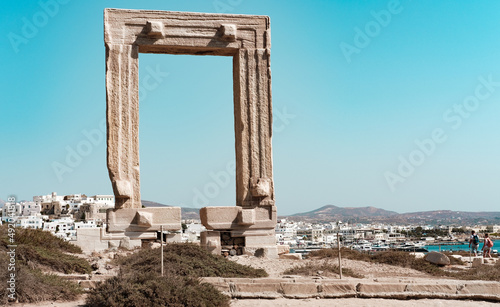 Naxos Island, Greece - 07.21.2021 : Temple of Appolo in Small Cyclades, monument on blue sky background, ancient roman architectural emblem of portara