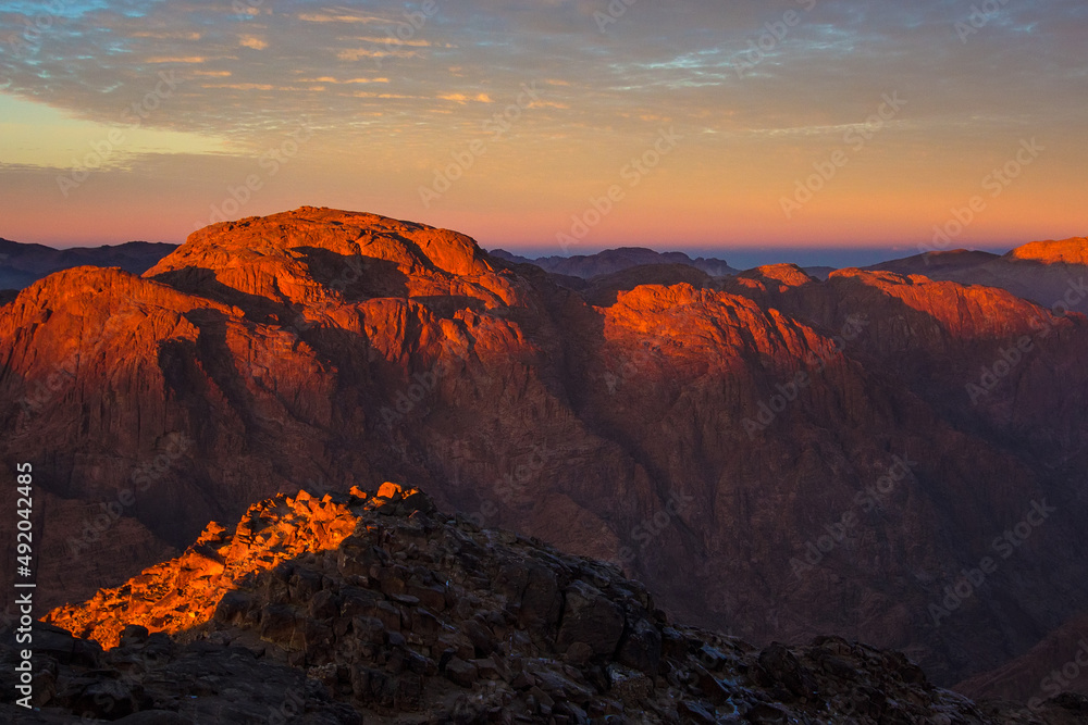 Sunrise on the summit of the Mount Sinai (Holy Mount Moses, Mount Horeb or Gabal Musa), Egypt, North Africa. Low exposure
