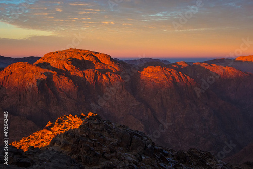 Sunrise on the summit of the Mount Sinai (Holy Mount Moses, Mount Horeb or Gabal Musa), Egypt, North Africa. Low exposure