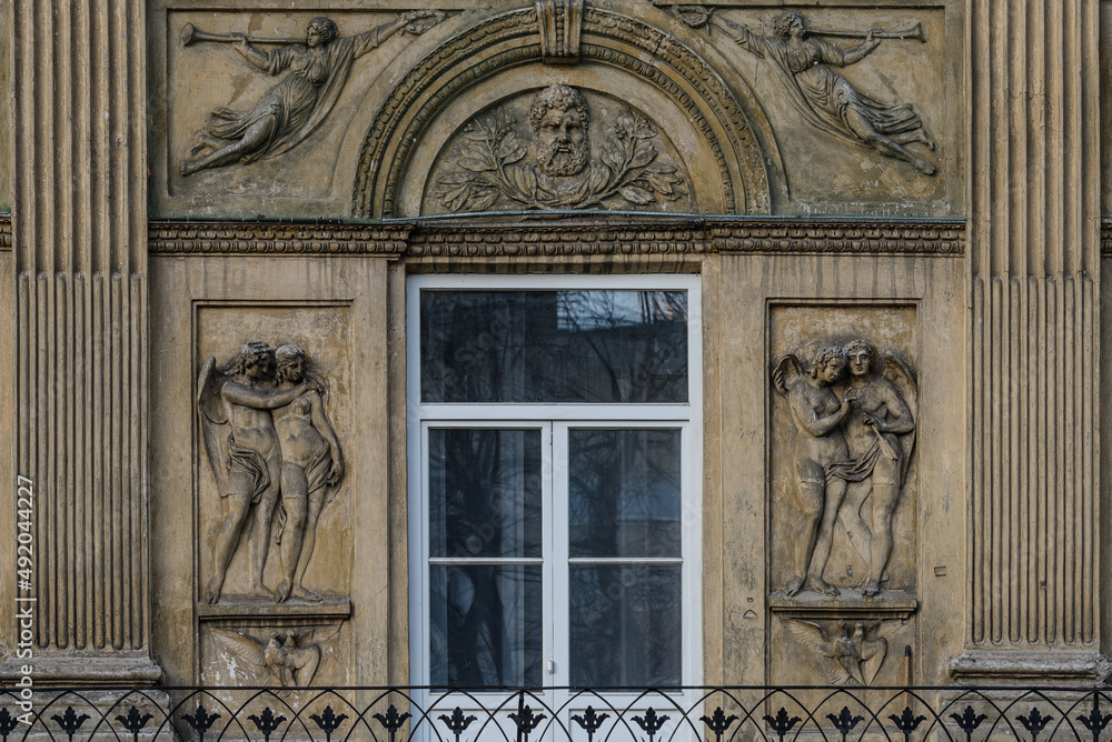 Elements of architectural decorations of buildings, sculptures and statues, public places in Lviv, Ukraine. Bas-relief of angels on the facade of an ancient building in the city center. 