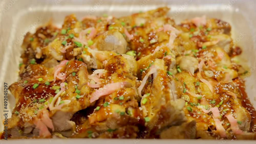 Woman hand open buffet heated trays and Teriyaki chicken's with sesame seeds in heated trays ready for service.
Woman hand open buffet heated trays and Teriyaki chicken's with sesame seeds in heated trays ready for service.