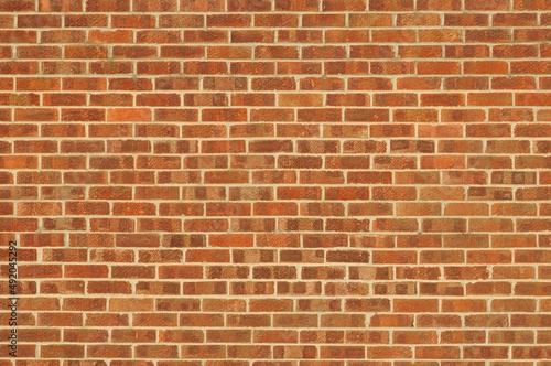 Wall with red / orange bricks. Abstract background