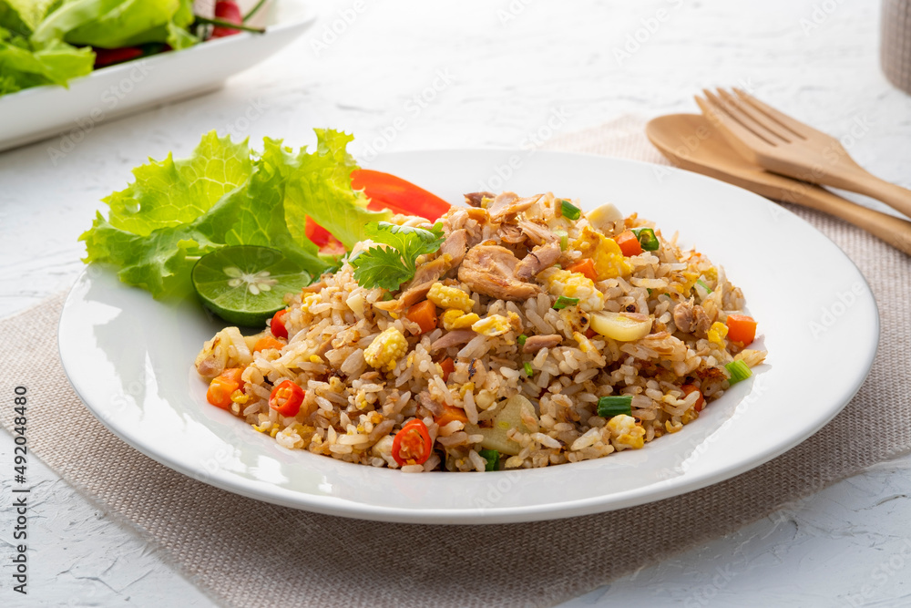 Fried Rice with canned Tuna fish.Quick and Easy Thai style spicy one dish meal on white plate Fried Rice with canned Tuna fish.Quick and Easy Thai style spicy one dish meal on white plate