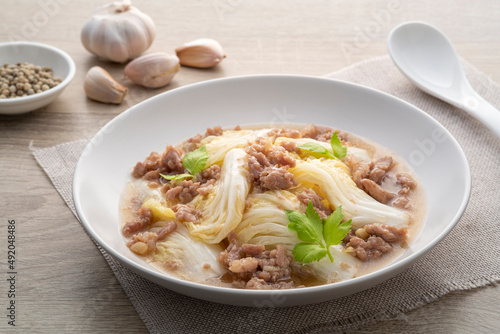 Stir-fried napa cabbage with minced pork with oyster sauce in white plate