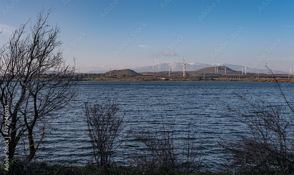 View of the Golan Hills and the snow covered Hermon Mountain Rnge in the background as seen from the water reservoir at the foot of Mount Bental, Golan Heights, Israel.	