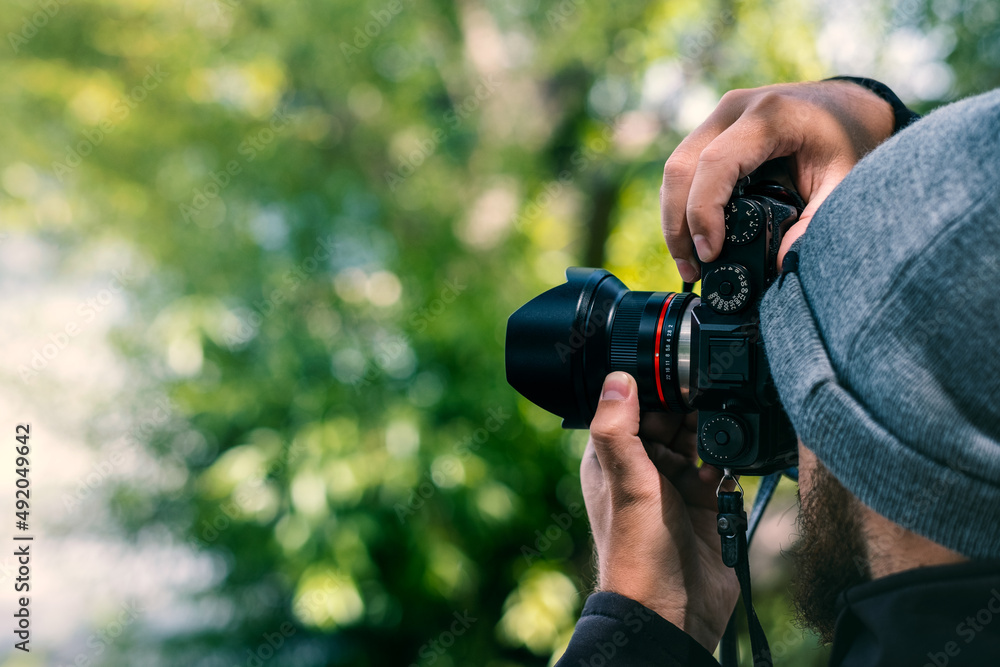 Fototapeta premium Photographer taking pictures in the woods outdoor forest nature. Course Lesson class learning photography 