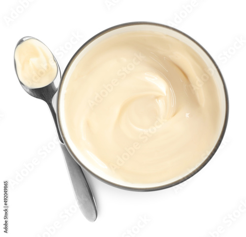 Ceramic bowl and spoon with mayonnaise on white background