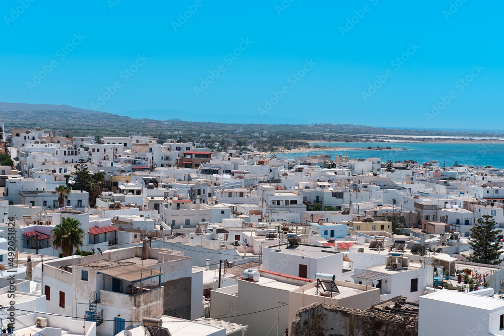 Naxos town view, blue sea, white greek buildings, sunny vacation day, tourism concept