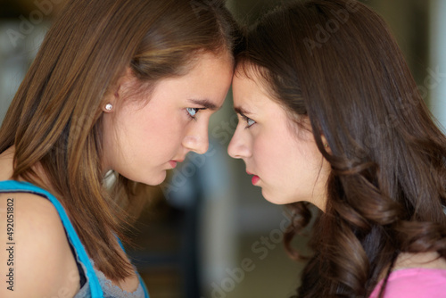 Sibling rivalry. Cropped shot of two sisters standing face to face in the midst of an argument.